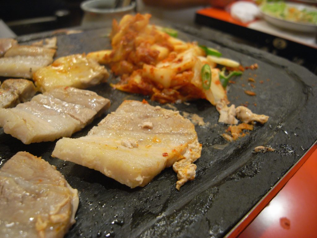 Tranches de poitrine de porc grillées sur un barbecue coréen